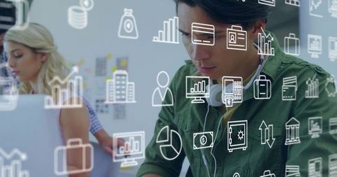 Young professional analyzing data with floating analytics icons in modern coworking space