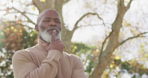 Thoughtful Senior Man Contemplating Nature in Garden