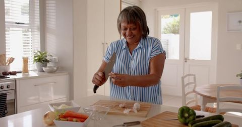 Senior Woman Preparing Healthy Meal in Kitchen