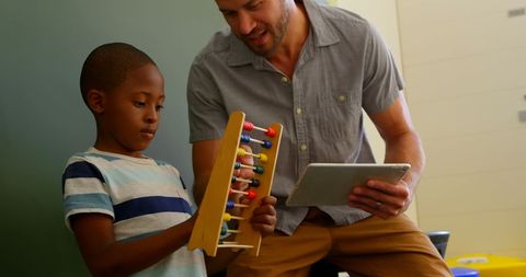Young Teacher Using Technology and Abacus in Classroom Interaction - Download Free Stock Images Pikwizard.com