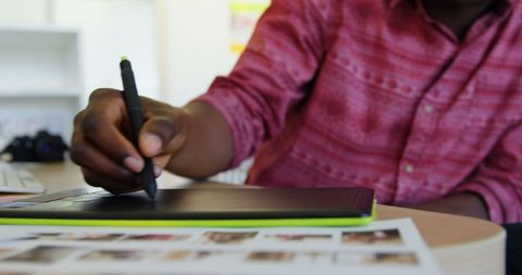 Young african american graphic designer using tablet in office