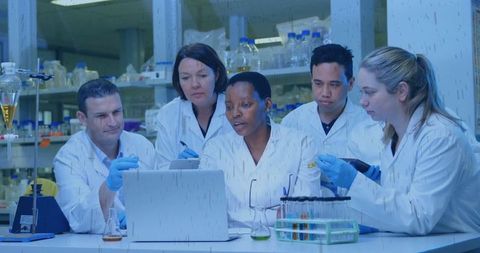 Diverse Team of Scientists Analyzing Data in Modern Research Lab