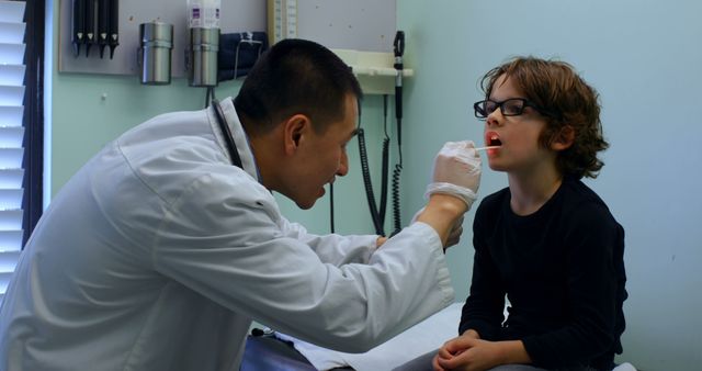 Doctor Examining Young Boy's Throat - Download Free Stock Images Pikwizard.com