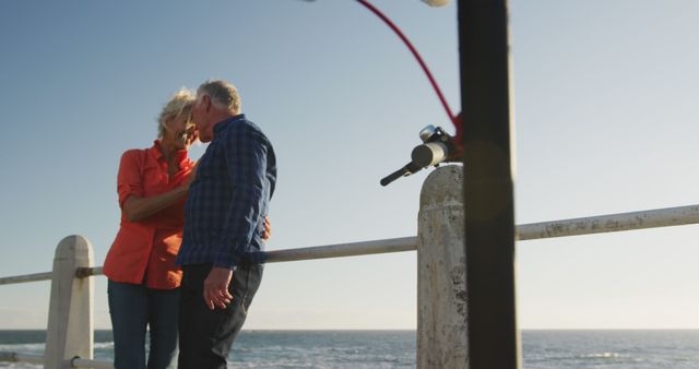 Senior Couple Embracing by Ocean on Sunny Day - Download Free Stock Images Pikwizard.com