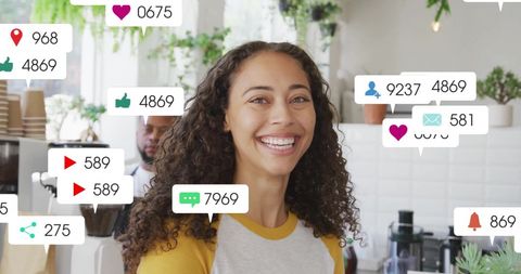 Smiling woman engaged in social media in cafe