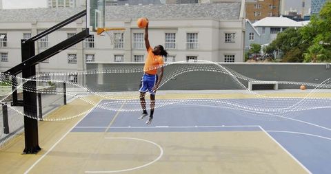 Athlete Dunking Ball on Rooftop Basketball Court Action