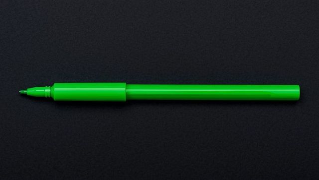 Vibrant green marker pen on charcoal background