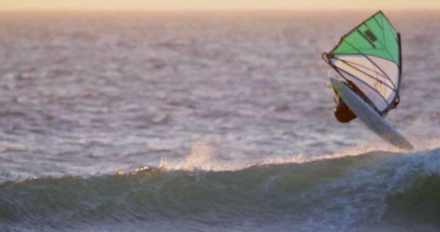 Windsurfer Catching A Wave During Sunset On The Ocean - Download Free Stock Images Pikwizard.com