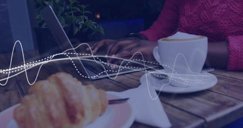 Typing Woman Working Remotely at Cozy Cafe Table with Laptop, Coffee and Croissant