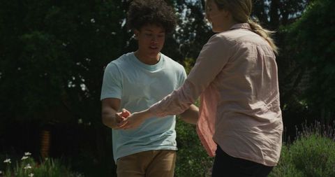 Joyful Couple Dancing in Lush Garden Outdoors