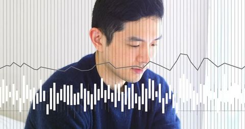 Contemplative asian man wearing navy sweater, displaying audio waveform and data visualization