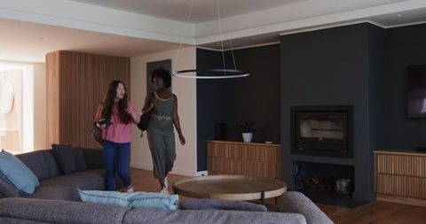 Diverse friends embracing adventure in comfortable hotel suite
