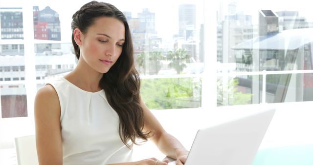 Focused Businesswoman Working On Laptop In Bright Modern Office - Download Free Stock Images Pikwizard.com