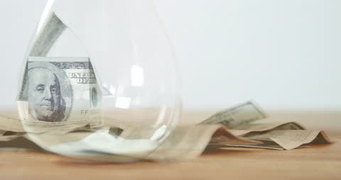 Hourglass Overlapping with Stack of Banknotes