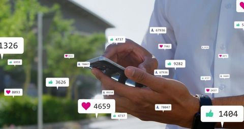 Man Tapping Smartphone with Floating Social Media Notification Bubbles Outdoors