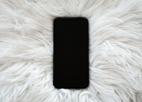 Technology smartphone with blank screen on fluffy white surface