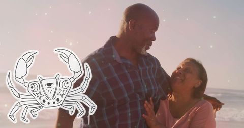 Senior Couple Enjoys Day at the Beach with Scorpio Symbol