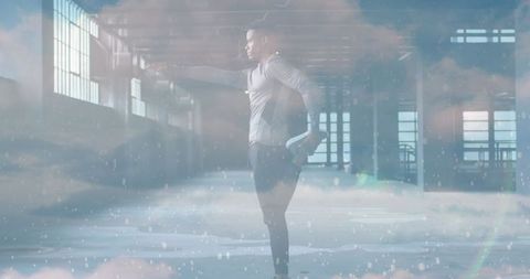 Man Stretching in Winter Warehouse with Cloud Overlay