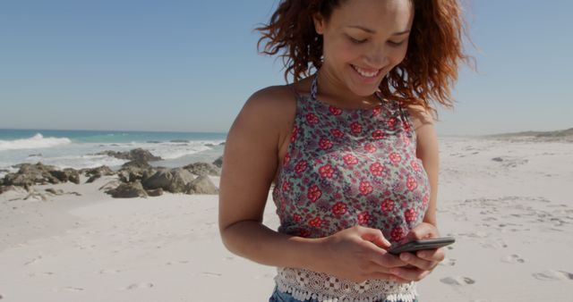 Smiling Woman Texting on Beach with Clear Sky Background - Download Free Stock Images Pikwizard.com