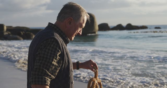 Senior Man Walking on Seashore Carrying Fishing Net at Sunset - Download Free Stock Images Pikwizard.com