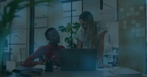 Two Female Coworkers Collaborating in Open-Plan Office Workspace