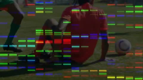 Soccer Player Executes Slide Tackle on Opponent Dribbling Ball