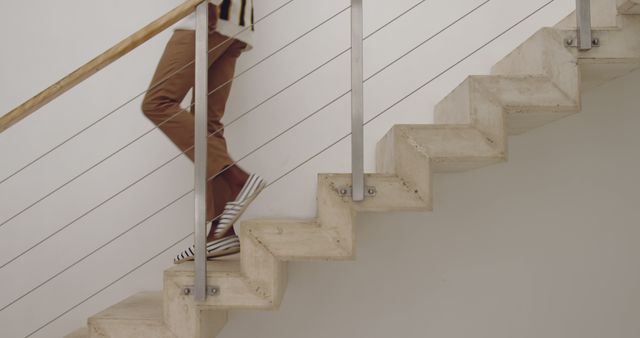 Person Walking Down Stylish Concrete Staircase With Modern Railings - Download Free Stock Images Pikwizard.com