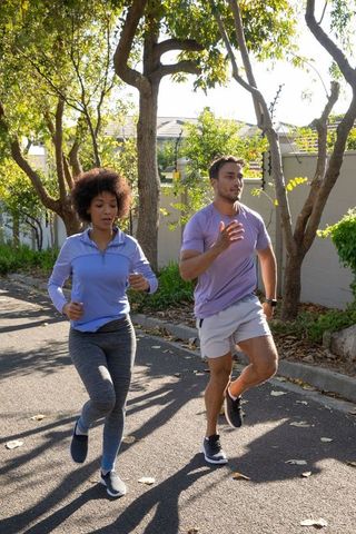 Diverse Runners Jogging in Suburban Neighborhood