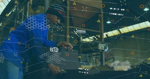 Machinist operating press bending sheet metal with augmented reality hud in workshop