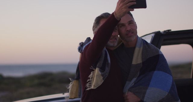 Couple enjoying quality time together by the beach. Perfect for promoting inclusivity, vacation packages, LGBTQ+ relationships, or outdoor adventures.