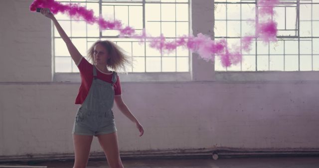 Young Woman Playing with Pink Smoke in Loft Setting - Download Free Stock Images Pikwizard.com