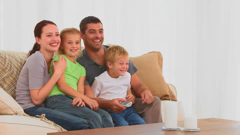 Happy Family Bonding While Watching TV at Home