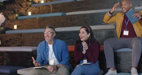 Clapping and Taking Notes during Workshop on Tiered Seating, Multicultural Team Engagement