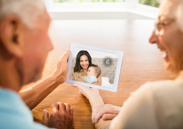Senior couple having a video chat on digital tablet at home
