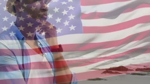Contemplative African American Overlaid with USA Flag at Beach