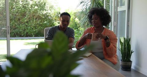 Couple Relaxing with Coffee While Working from Home