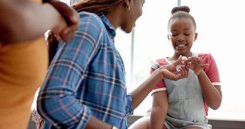 Mother and Daughter Sharing Quality Time Preparing Meal Together