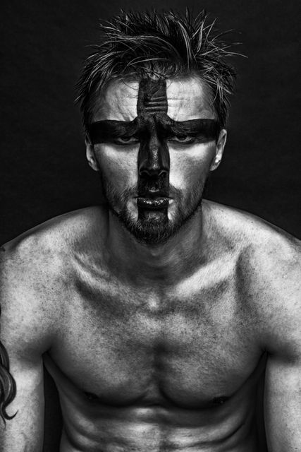 Warrior-themed Man with Black Face Paint in Monochrome - Download Free Stock Photos Pikwizard.com