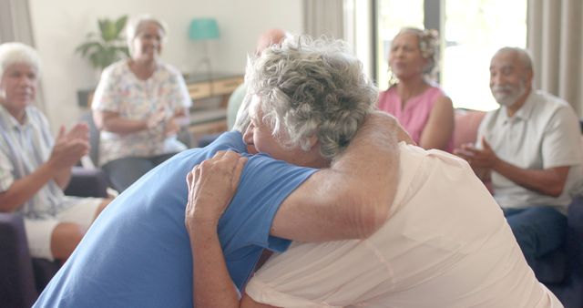 Caucasian male and female senior colleagues hugging in therapy group. Group therapy, support and mental health awareness, unaltered.