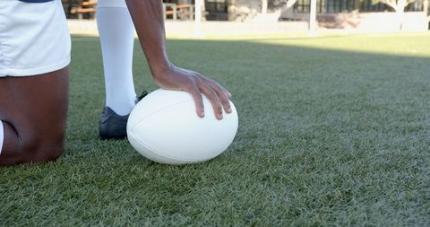 Athlete Preparing for Kick on Sunny Field