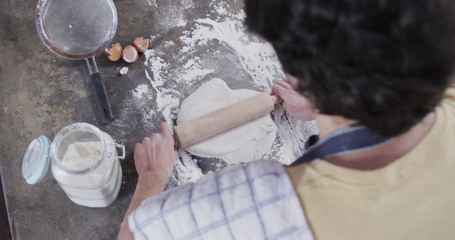Man Rolling Out Dough in Kitchen with Baking Utensils - Download Free Stock Images Pikwizard.com