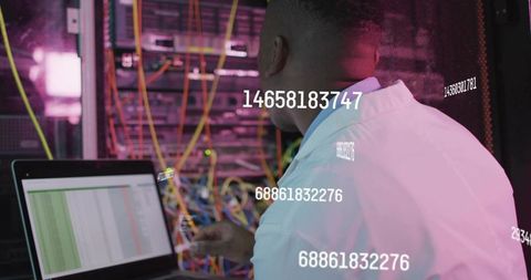 Datacenter technician inspecting server rack with laptop, neon cabling and data overlay