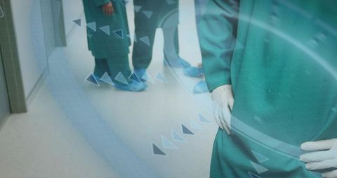 Surgeon Standing in Hospital Corridor Wearing Green Scrubs with Digital Medical Overlay