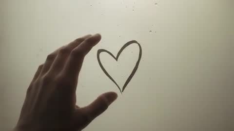 Hand Tracing Heart on Fogged Window, Tender Touch Close-Up Video for Romance