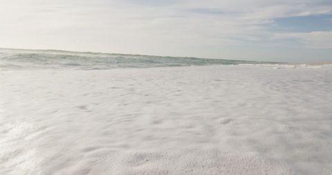 Tranquil Beach with Soft Ocean Waves and Expansive Sky - Download Free Stock Images Pikwizard.com