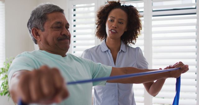 Physical Therapist Guiding Senior Man With Resistance Band Exercise - Download Free Stock Images Pikwizard.com