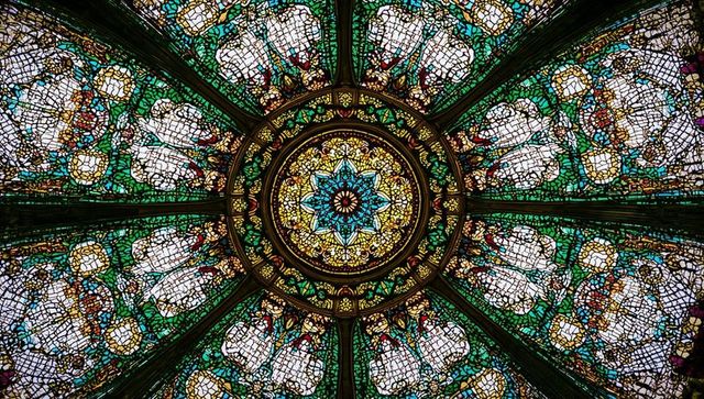 Intricate stained glass dome illuminating decorative architecture