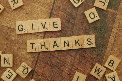 Scrabble tiles arranged to spell give thanks message