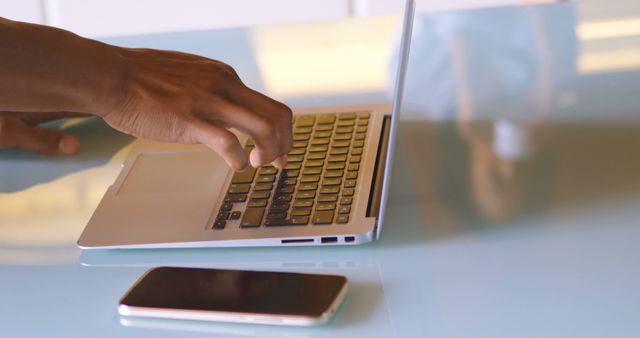 Person Typing on Laptop at Modern Glass Desk with Smartphone - Download Free Stock Images Pikwizard.com