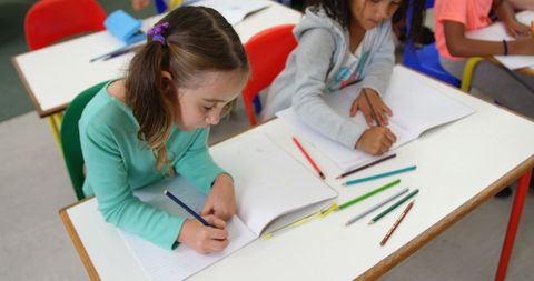 Young Students Writing During Classroom Activity - Download Free Stock Images Pikwizard.com